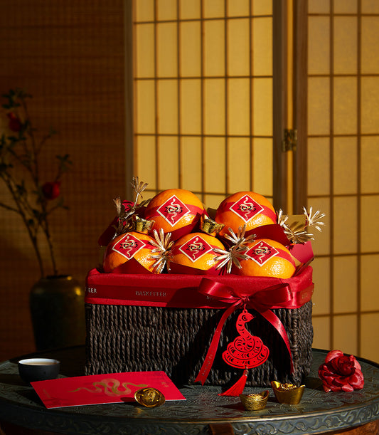 Basketeer luxury gift basket Bangkok filled with festive oranges and gold accents for Chinese New Year. Premium hamper delivery Thailand.