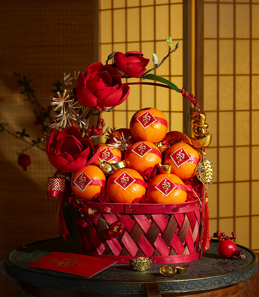 Elegant red and brown woven gift basket filled with lucky oranges, golden ingots, and auspicious symbols for Chinese New