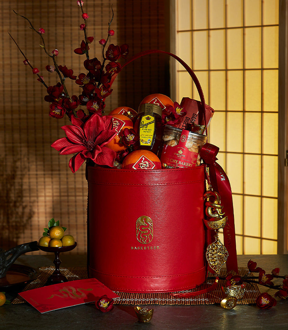 Red leather luxury gift basket with honey, bakery treats, and festive florals for Chinese New Year