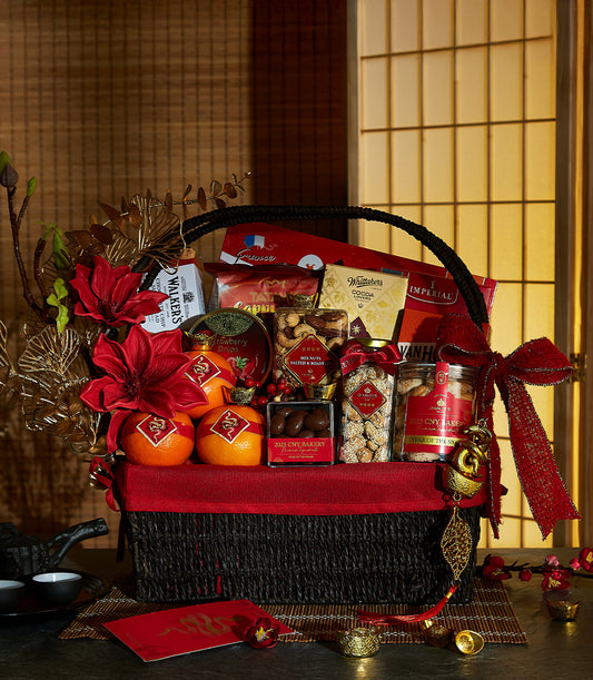 Luxe woven gift basket with gold dragon oranges, gourmet nuts, chocolates, and red festive ribbons for Chinese New Year