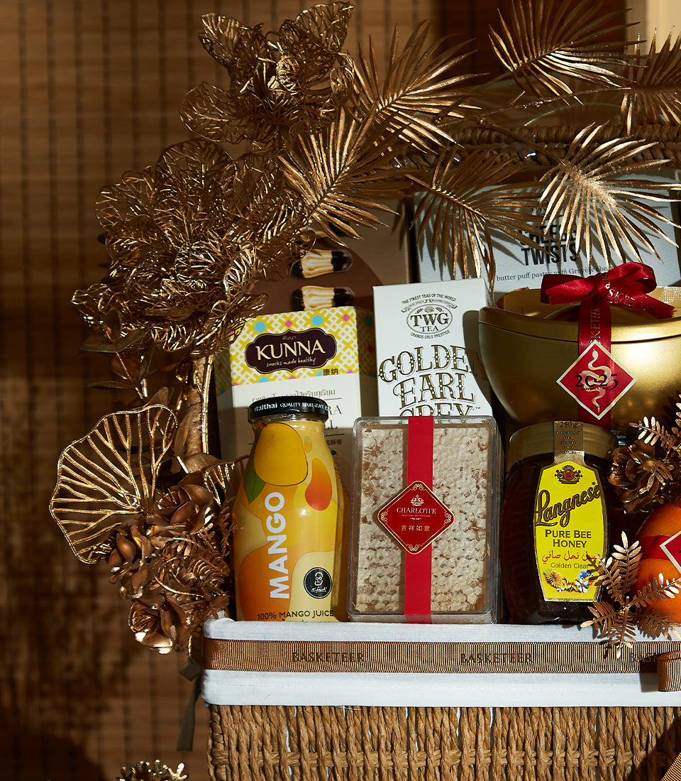 Luxury Prosperity Celebration basket with red wine, gourmet treats, golden leaf accents, and festive ribbon