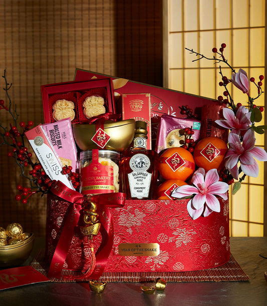 Luxury red and gold hamper with pastries, chocolates, and festive ornaments for Chinese New Year