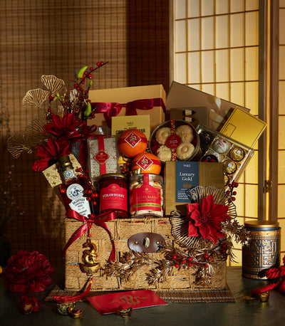Luxury red and gold CNY hamper with gourmet treats, cookies, chocolates, and snake charm for Year of the Snake celebrations