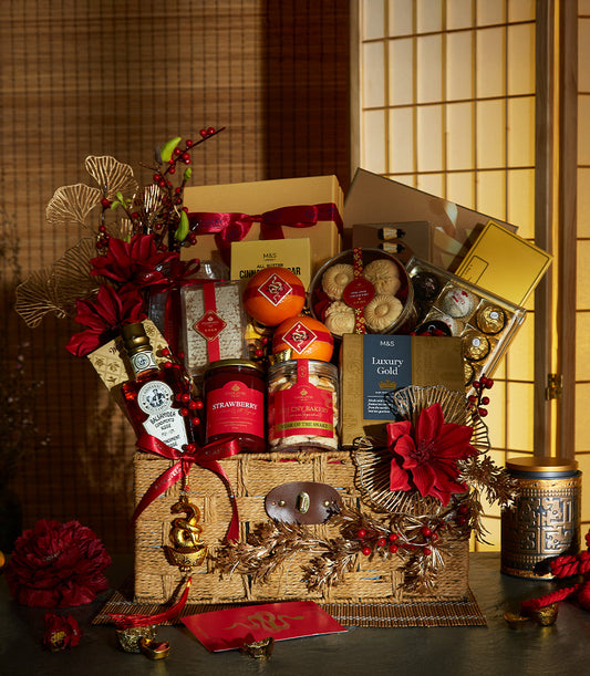 Luxury red and gold CNY hamper with gourmet treats, cookies, chocolates, and snake charm for Year of the Snake celebrations