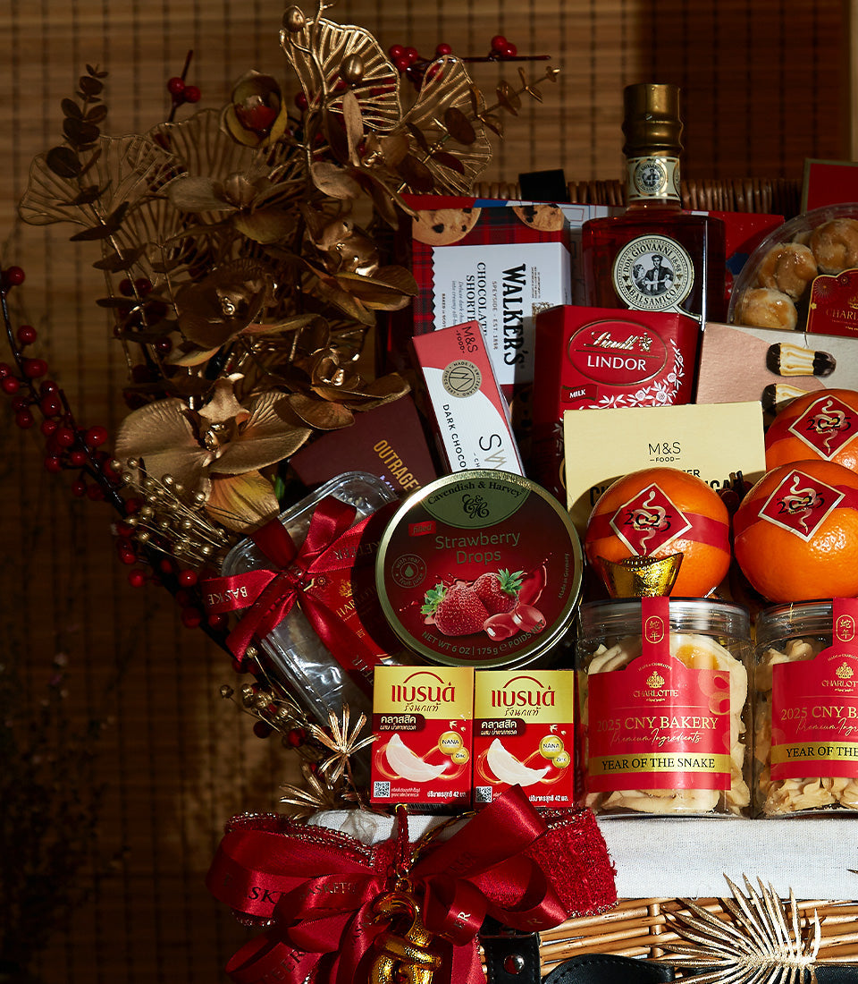 Luxurious Chinese New Year wine and gourmet gift basket with red berries, golden accents, premium chocolates, shortbread,