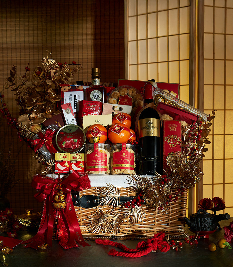 Chinese New Year wine and sweets gift hamper with red wine, spirits, chocolates, cookies, and lucky oranges with snake