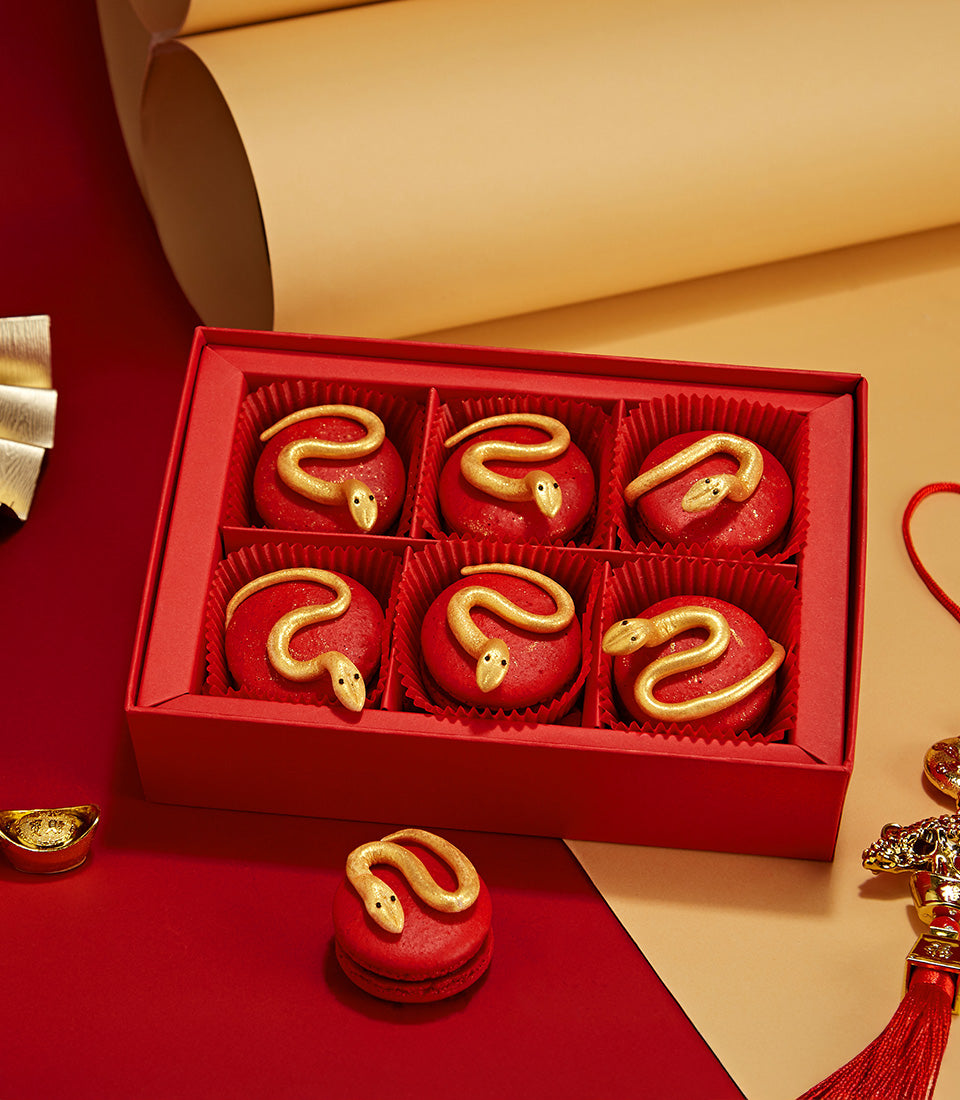 Year of the Snake red macarons box with golden snake designs for Chinese New Year celebrations