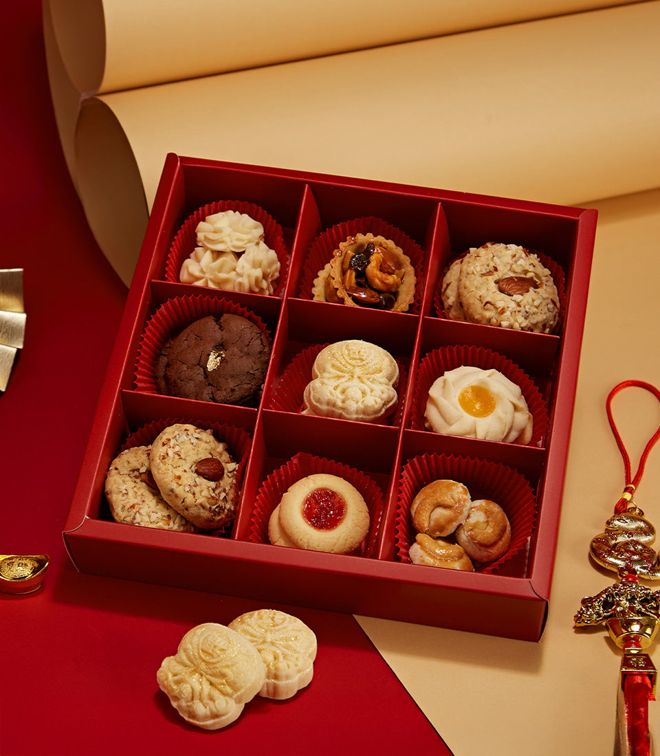 Chinese New Year assorted cookie gift box with almond tarts, chocolate cookies, and jam pastries in luxury red presentation
