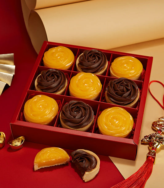 Luxury citrus and chocolate rose tarts in red gift box, nine handcrafted pieces with glossy lemon and dark chocolate finishes