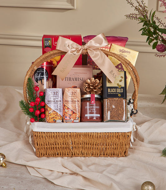 Premium woven gift basket with gourmet coffee, plant-based milk, jam, and artisan chocolates for New Year gifting