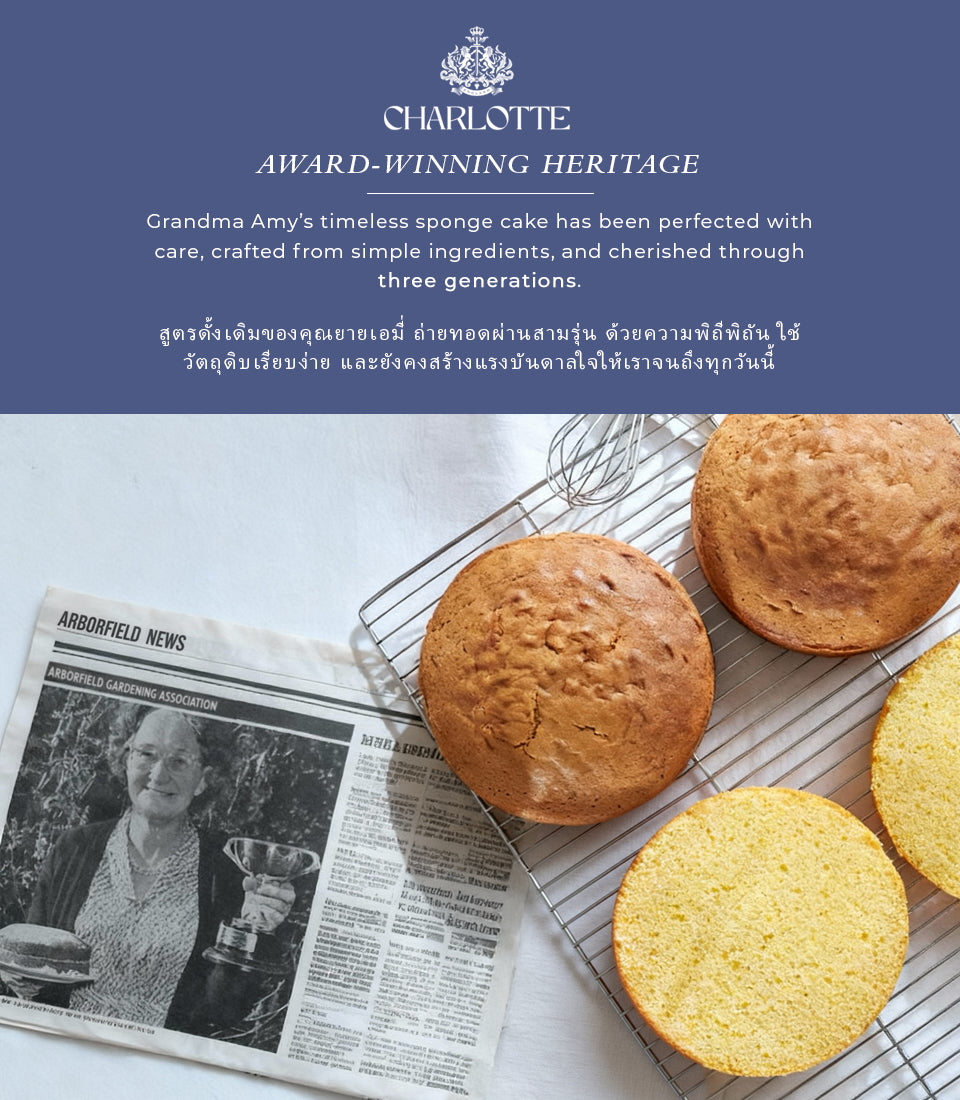 Thai-style strawberry Victoria sponge cake, golden-baked whole and sliced on cooling rack with vintage newspaper clipping
