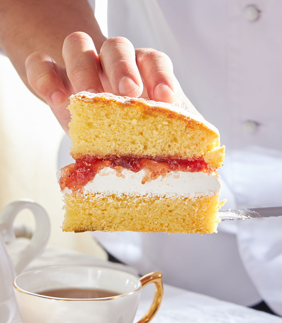 Classic Victoria sponge slice with strawberry jam and cream, British bakery cake gift