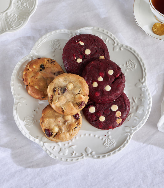 White chocolate macadamia and red velvet artisan cookies on embossed ceramic plate