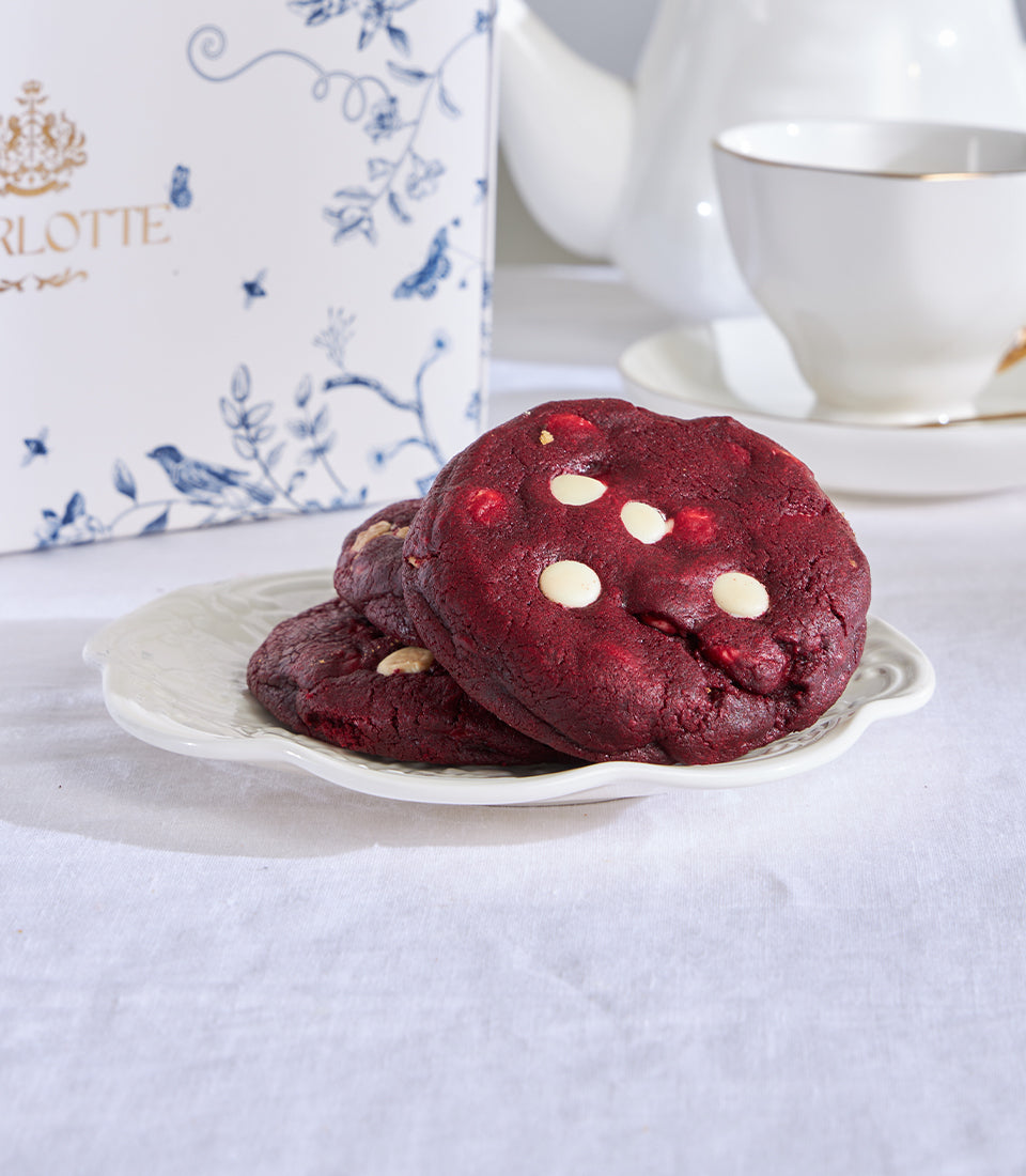 Red velvet cookies with white chocolate chips on scalloped plate, elegant tea-time gift presentation