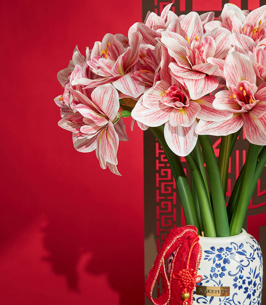 Basketeer Chinese New Year gift: Striking artificial amaryllis in a blue and white vase, plus festive red tassel. Premium hamper delivery Thailand.