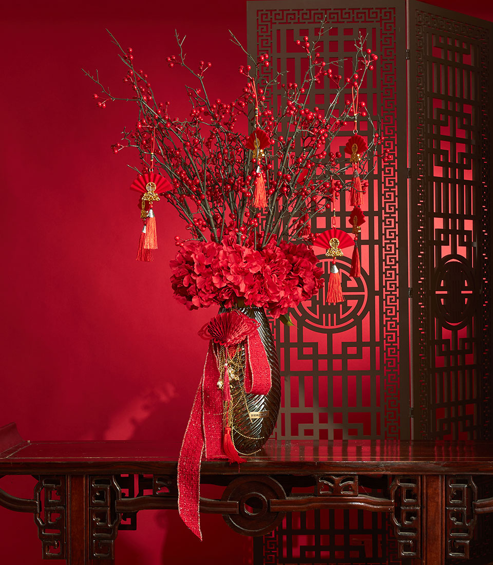 Red berry and hydrangea arrangement with festive ornaments for Chinese New Year celebrations
