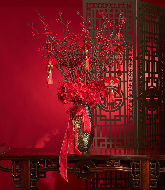Red berry and hydrangea arrangement with festive ornaments for Chinese New Year celebrations
