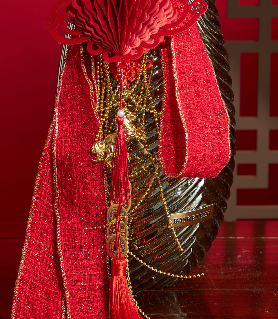Red berry and hydrangea arrangement with gold beads, tassel, and festive ornaments for Chinese New Year