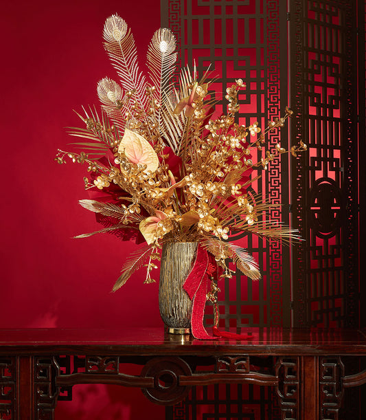 Basketeer premium hamper delivery Thailand: gold floral arrangement with feathers and red ribbon. A luxurious corporate gift for Chinese New Year.
