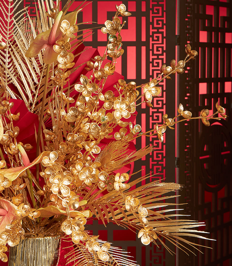 A luxurious Basketeer corporate gift arrangement: gold flowers, anthuriums, and palm fronds create a premium floral gift, perfect for Chinese New Year in Bangkok.