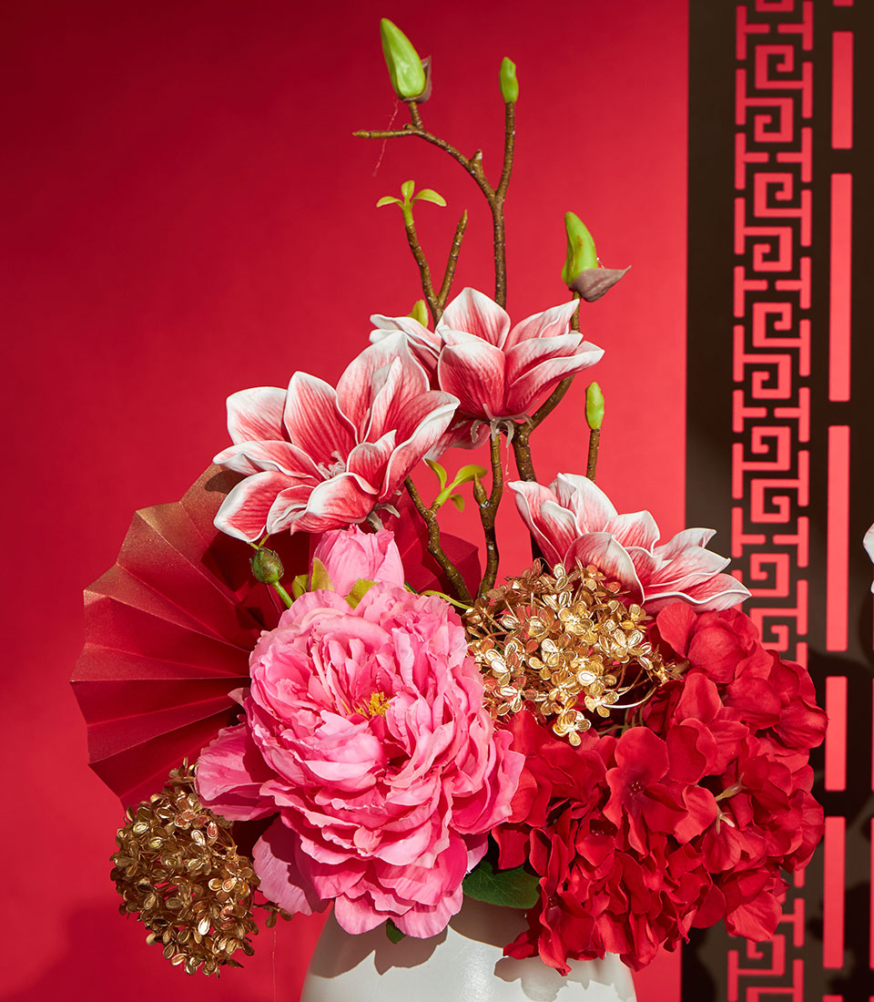 Basketeer's elegant Chinese New Year gift: Red & gold artificial flower arrangement with peonies, hydrangeas and ornamental fan. A premium hamper delivery in Thailand.