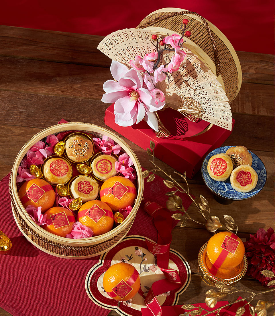 Bamboo basket of mandarin oranges and sesame pastries with gold ingots, Chinese New Year gift set