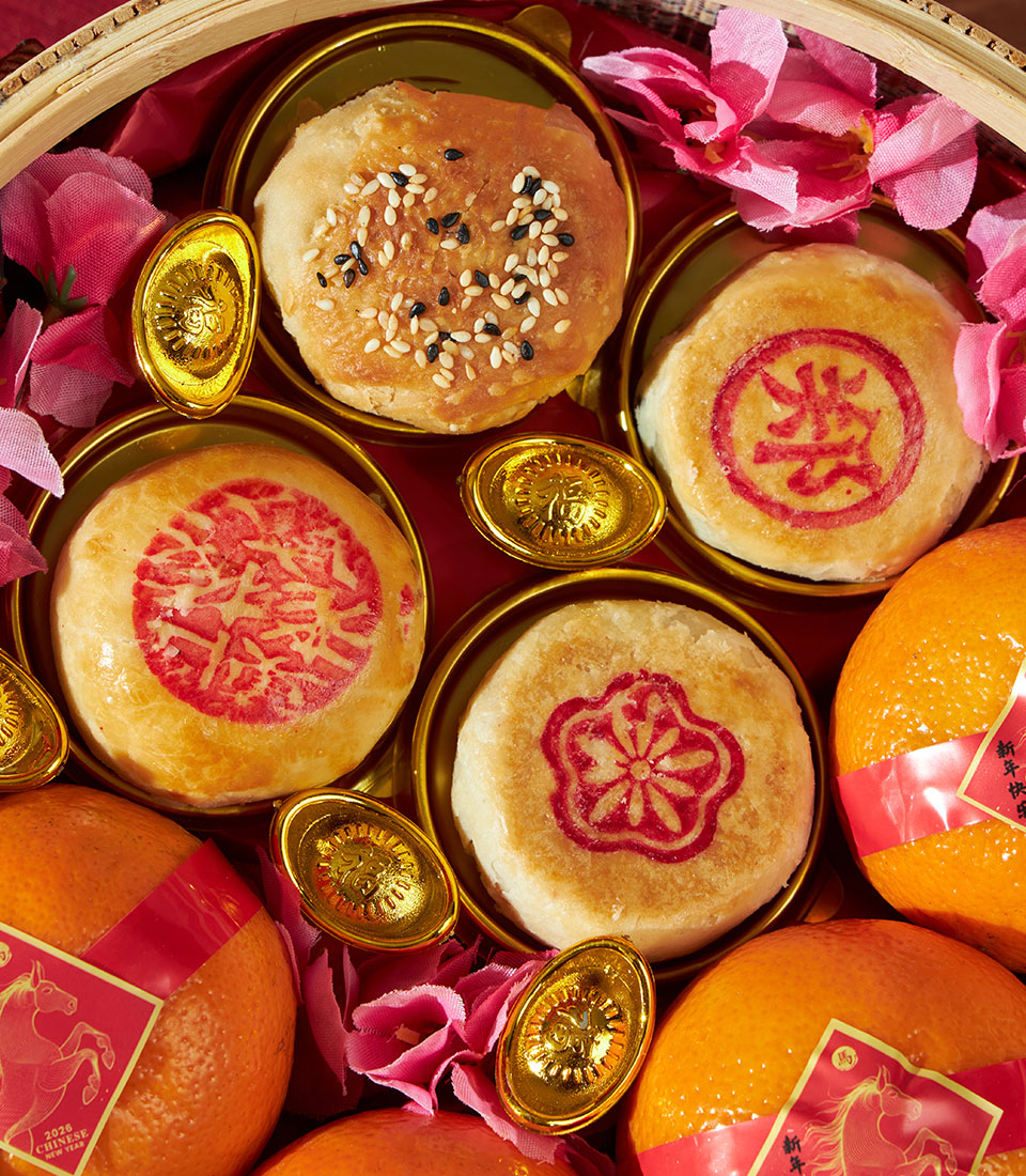 Mandarin oranges and red-stamped pastries gift set with golden sycee for Chinese New Year celebrations