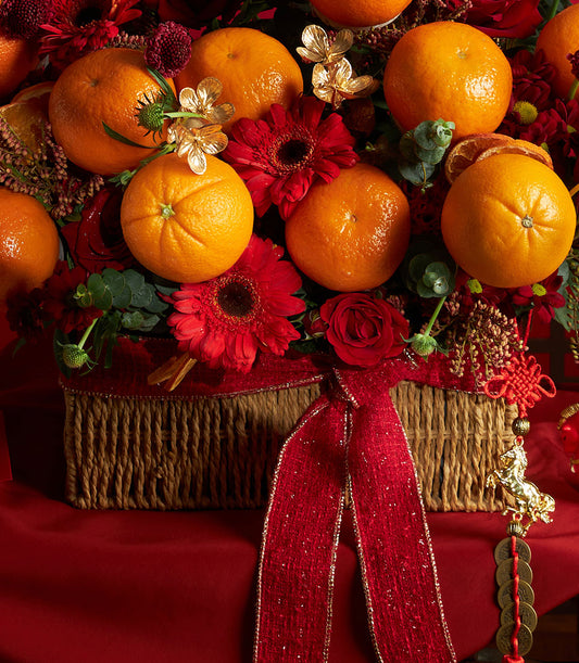 Mandarin orange and red rose luxury gift basket with gold accents and traditional auspicious charms for Chinese New Year