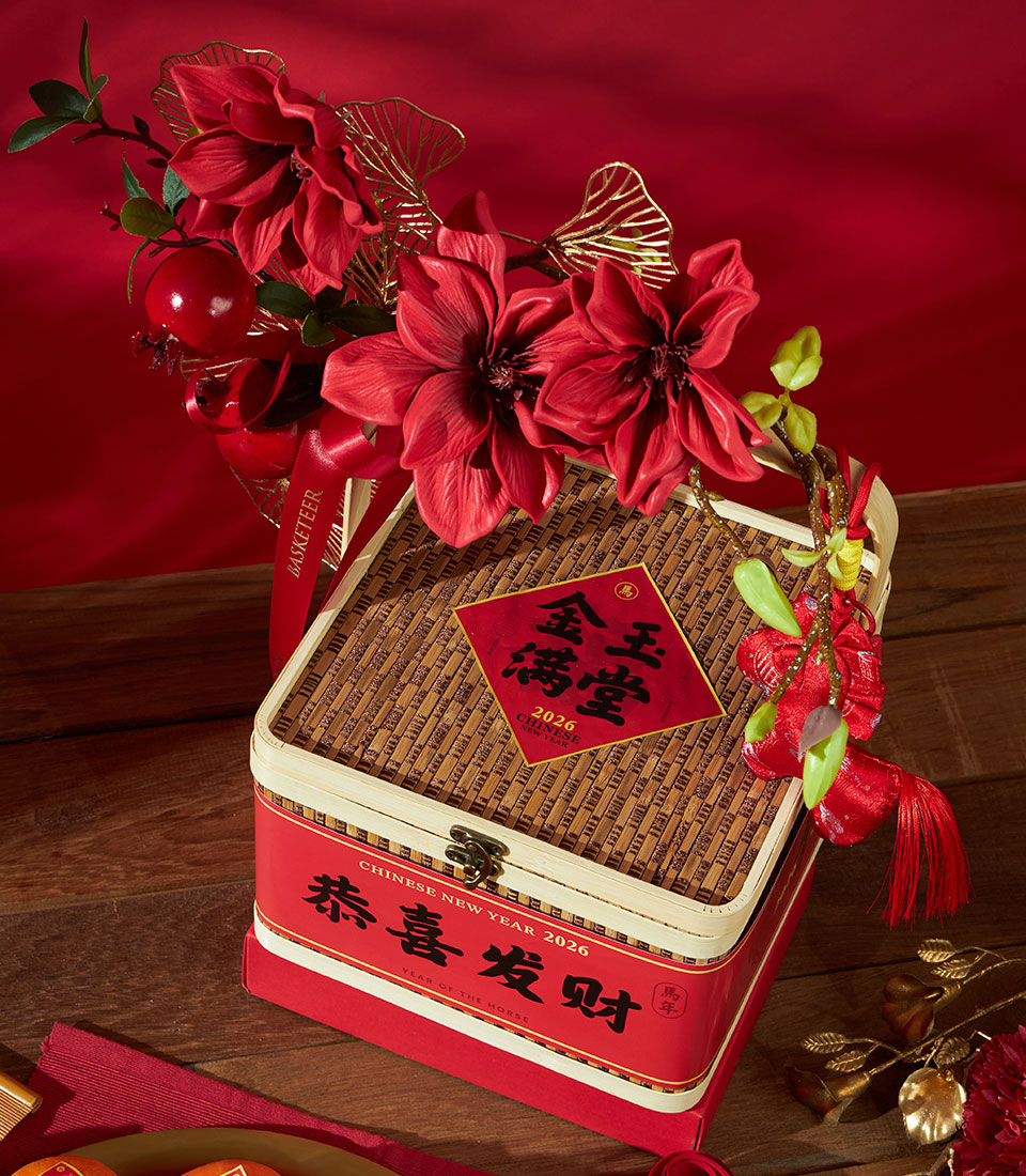 Festive Chinese New Year gift box with mandarin oranges and pastries, red base and woven bamboo lid with gold ginkgo accents