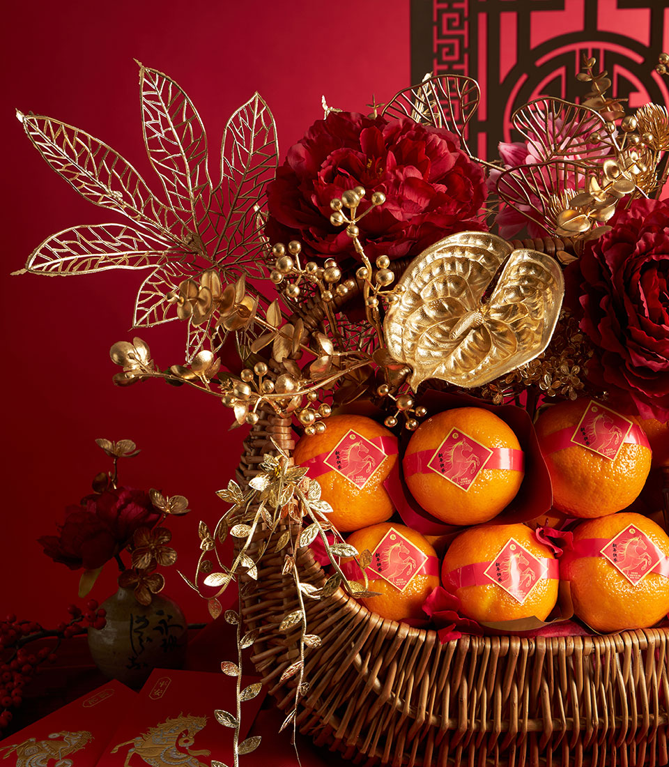 Mandarin oranges and cookies gift basket with red peonies, gold accents, and lucky horse design for Chinese New Year