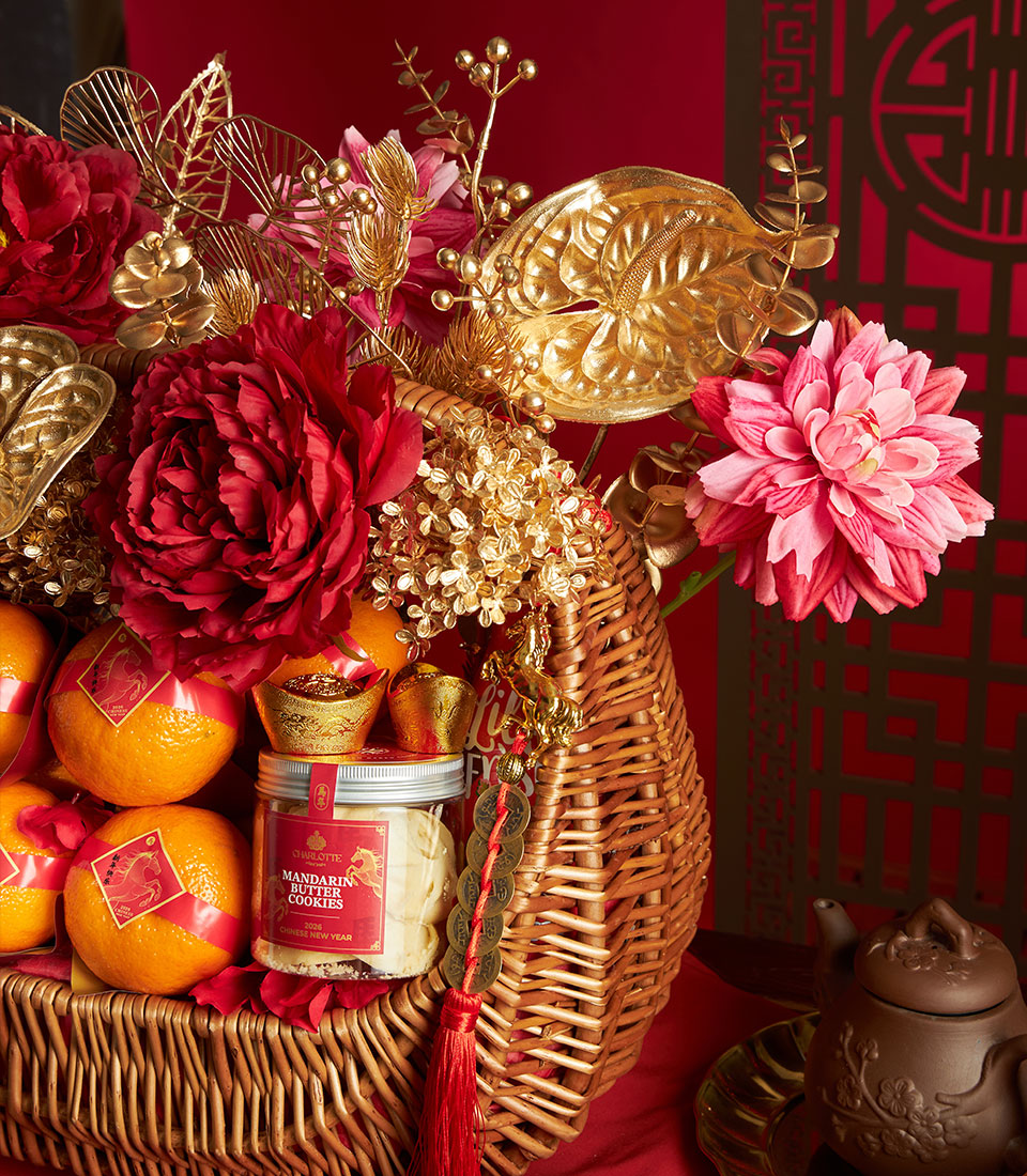Woven wicker gift basket with red peonies, mandarin oranges, and mandarin butter cookies for Chinese New Year