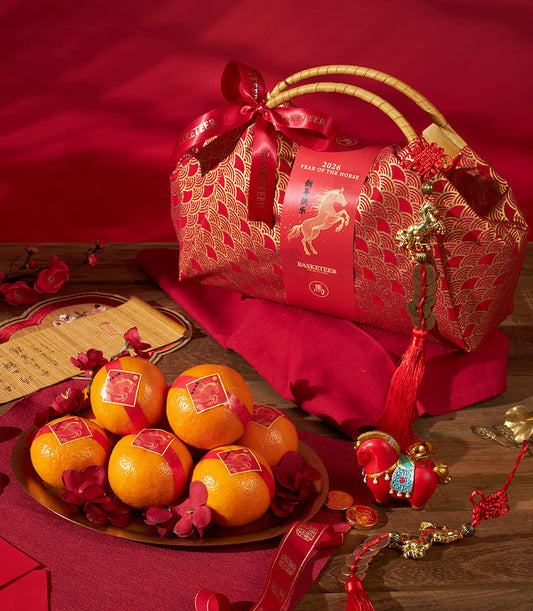 Luxury red gift basket with gold fan pattern, mandarin oranges, and Year of the Horse 2026 decoration for Chinese New Year