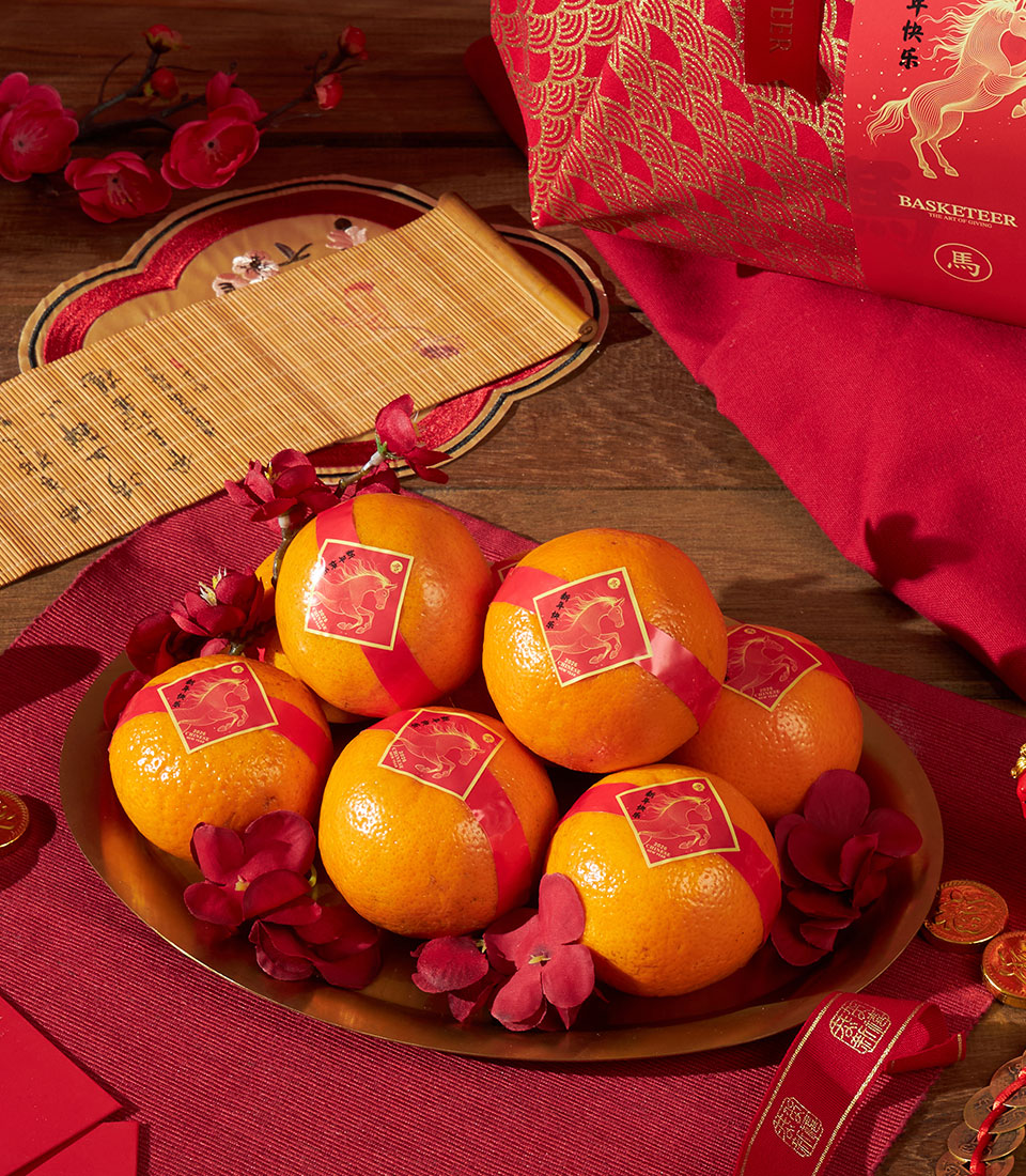 Red fabric mandarin orange gift bag with tangerines and golden horse design for Chinese New Year