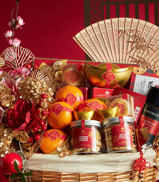 Luxury Chinese New Year gift hamper with red and gold accents, featuring citrus, artisan cookies, premium coffee, and