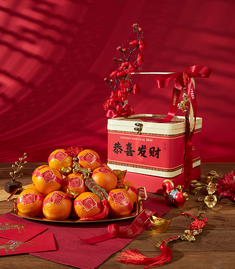 Festive Chinese New Year mandarin oranges gift box with red tiered packaging, gold horse charms, and lucky red envelopes on