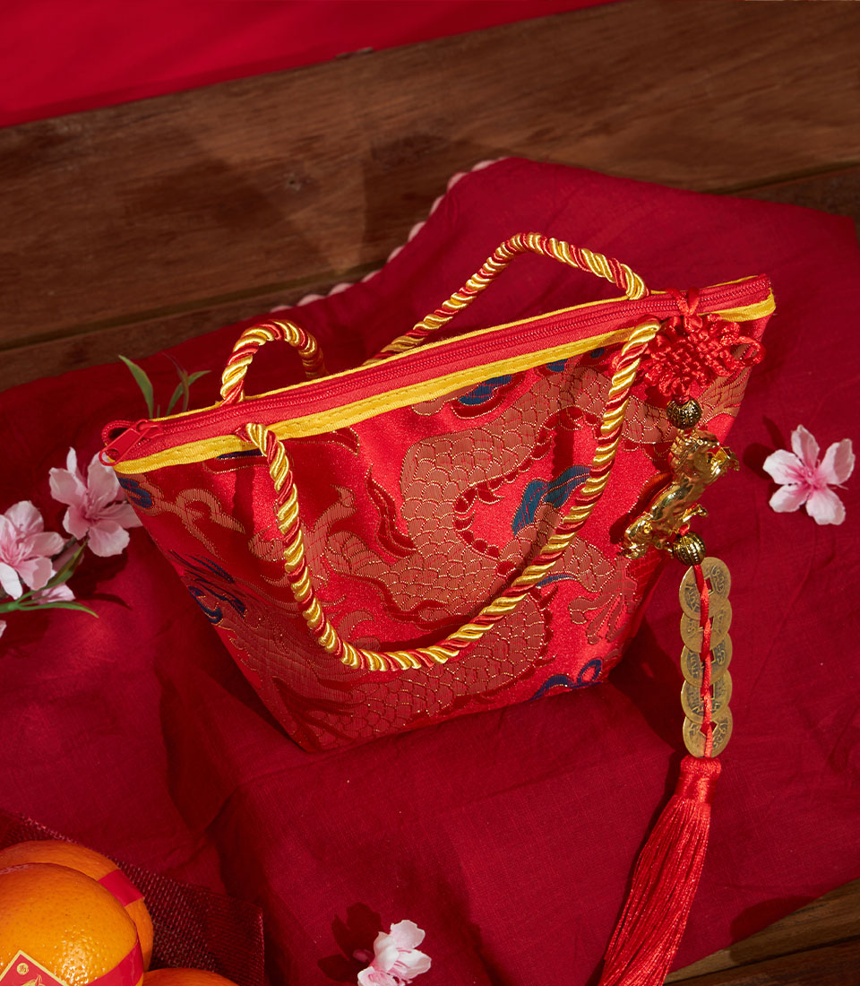 Premium red dragon gift bag with mandarin oranges and golden coin charm for Chinese New Year