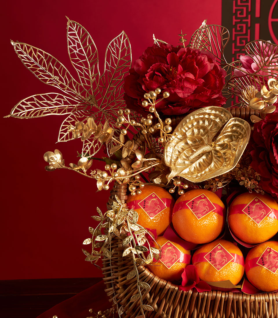 Luxury mandarin orange gift basket with red peonies and gold accents for Chinese New Year