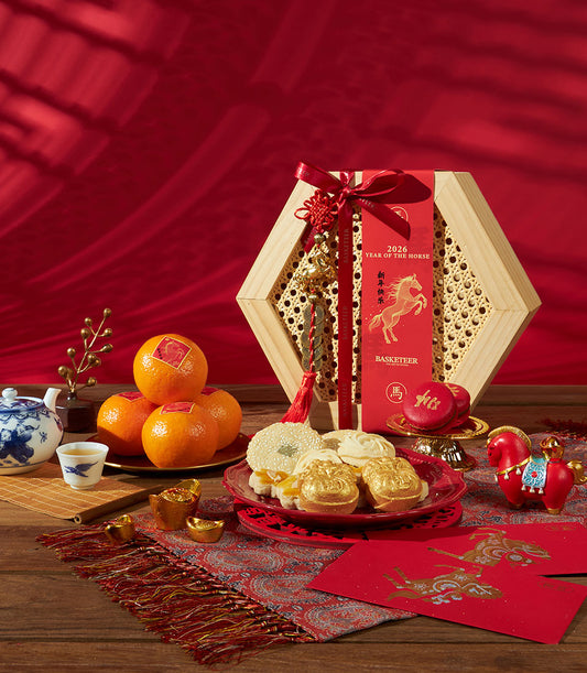 Hexagonal wooden gift box with Charlotte Bakery cookies, mandarin oranges, and Chinese New Year horse figurine on red