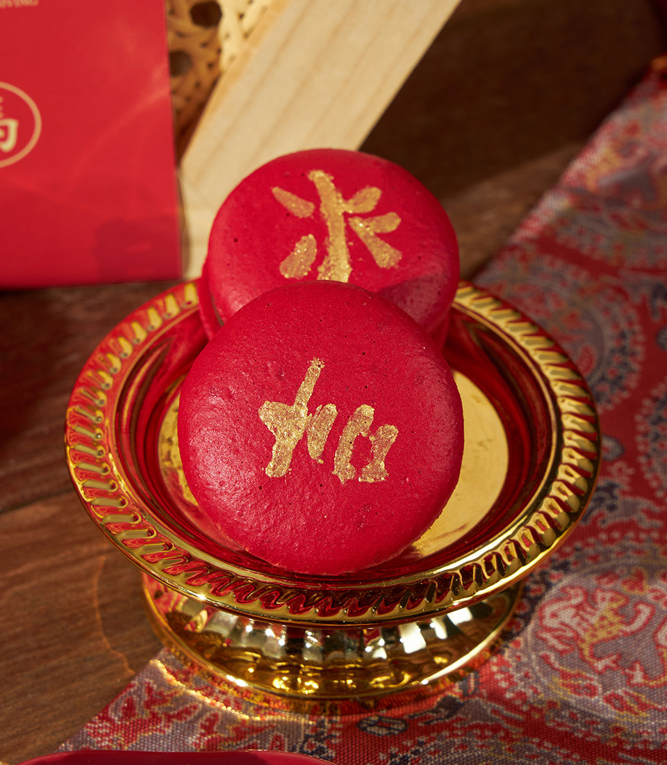 Red macarons with gold Chinese characters for Lunar New Year, artisan Charlotte Bakery gift