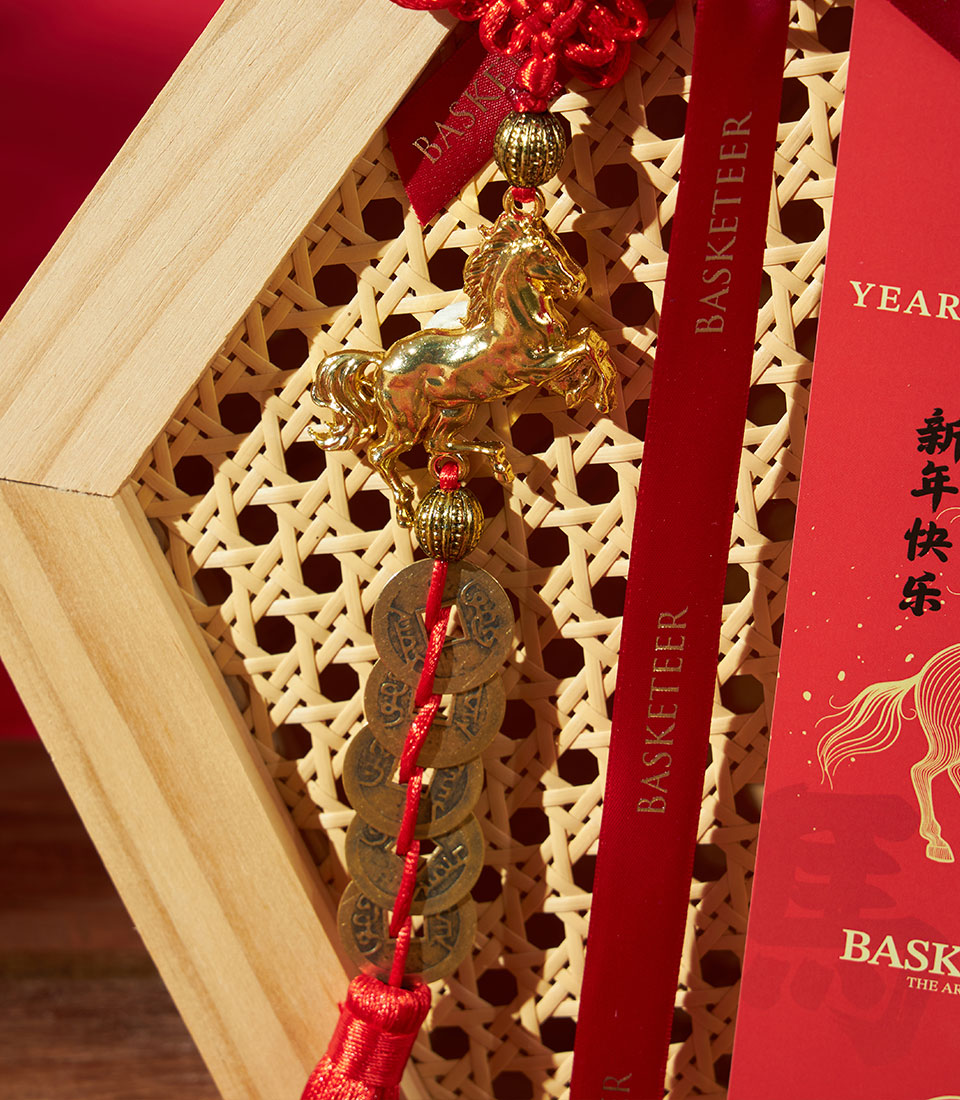 Golden horse charm and Chinese coins with red tassel on luxury Mandarin gift set hamper for Chinese New Year