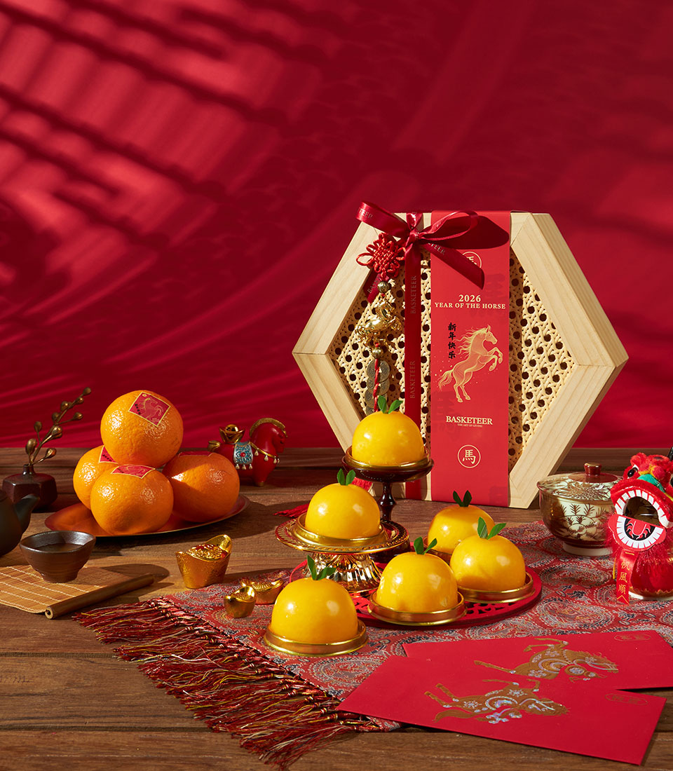 Mandarin and creamy mandarin cake gift set in hexagonal rattan box with fresh oranges, golden desserts, and Year of the