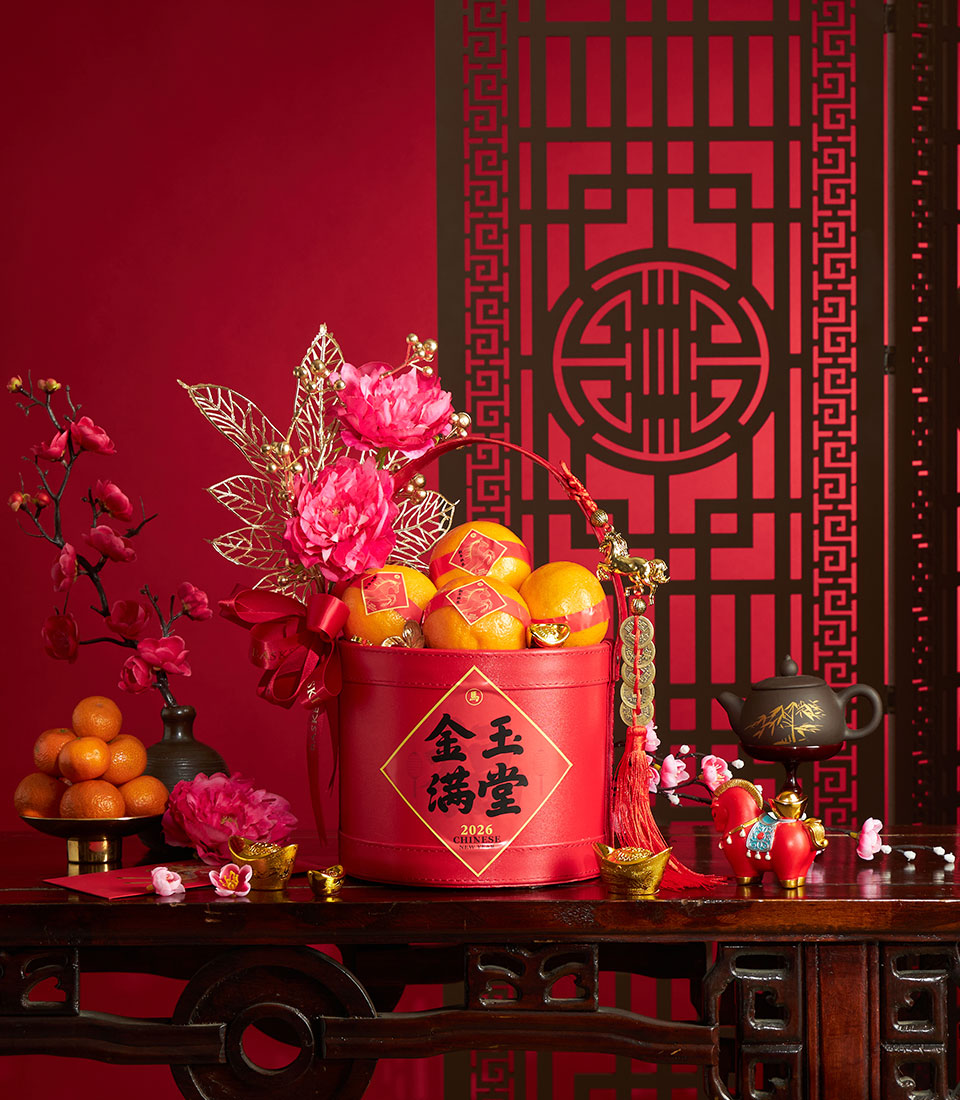 Chinese New Year mandarin orange gift basket with red box, artificial pink peonies, plum blossoms, and gold accents