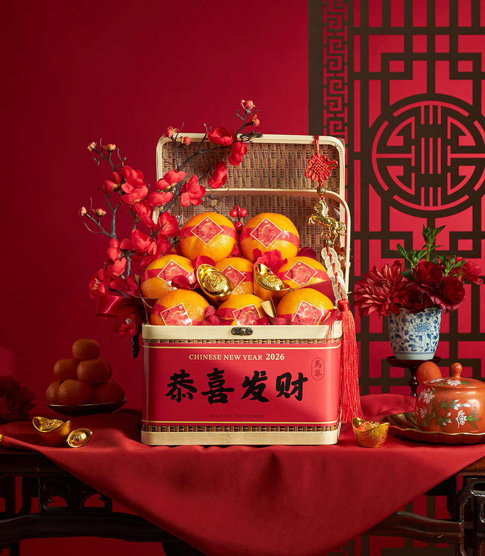 Festive red tin gift basket with mandarin oranges, gold ingots, and plum blossoms for Chinese New Year