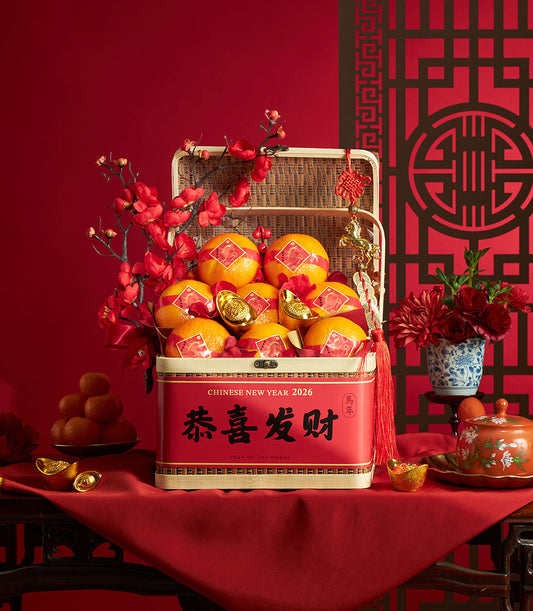 Festive red tin gift basket with mandarin oranges, gold ingots, and plum blossoms for Chinese New Year