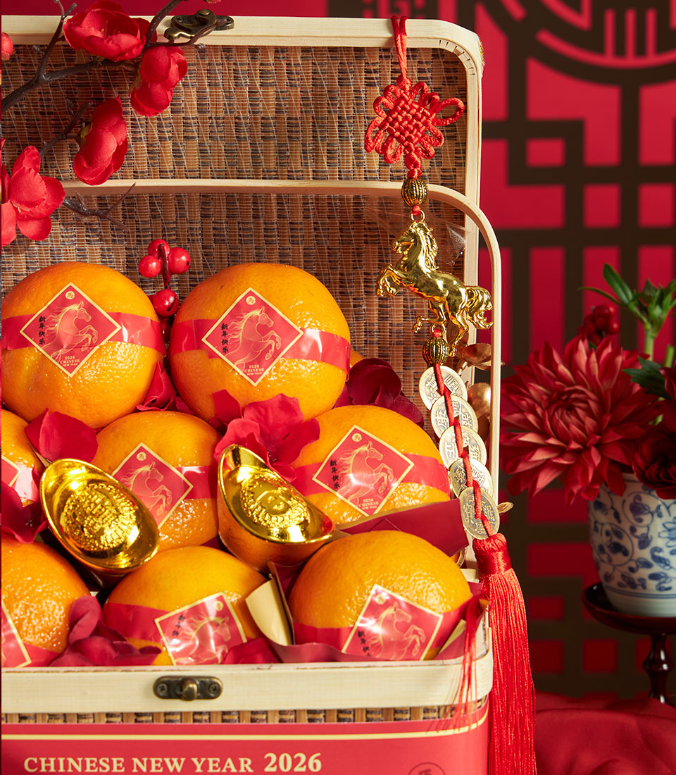 Festive mandarin orange basket with red silk trims, gold horse charms, and traditional Chinese New Year decorations in woven