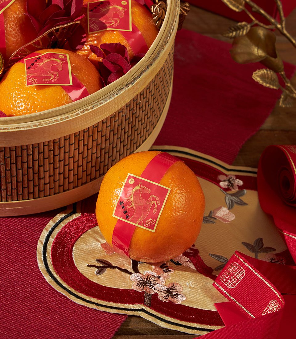 Festive mandarin oranges basket with red and gold labels for Chinese New Year gift, featuring bamboo weave and decorative