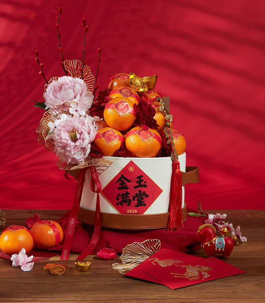 Premium Chinese New Year mandarin orange gift bucket with pink peonies, red berries, and gold accents by Basketeer