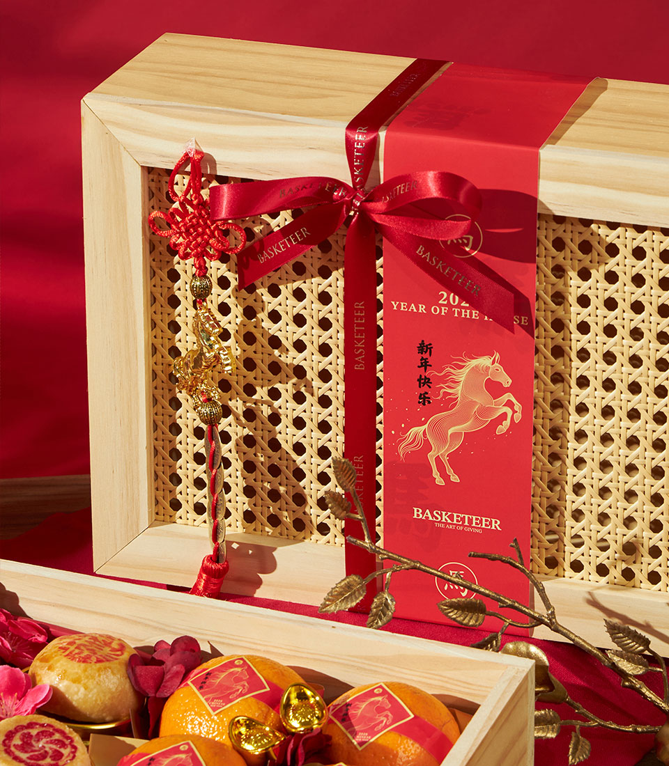 Mandarin oranges and tea gift box with red ribbon and gold horse design for Chinese New Year