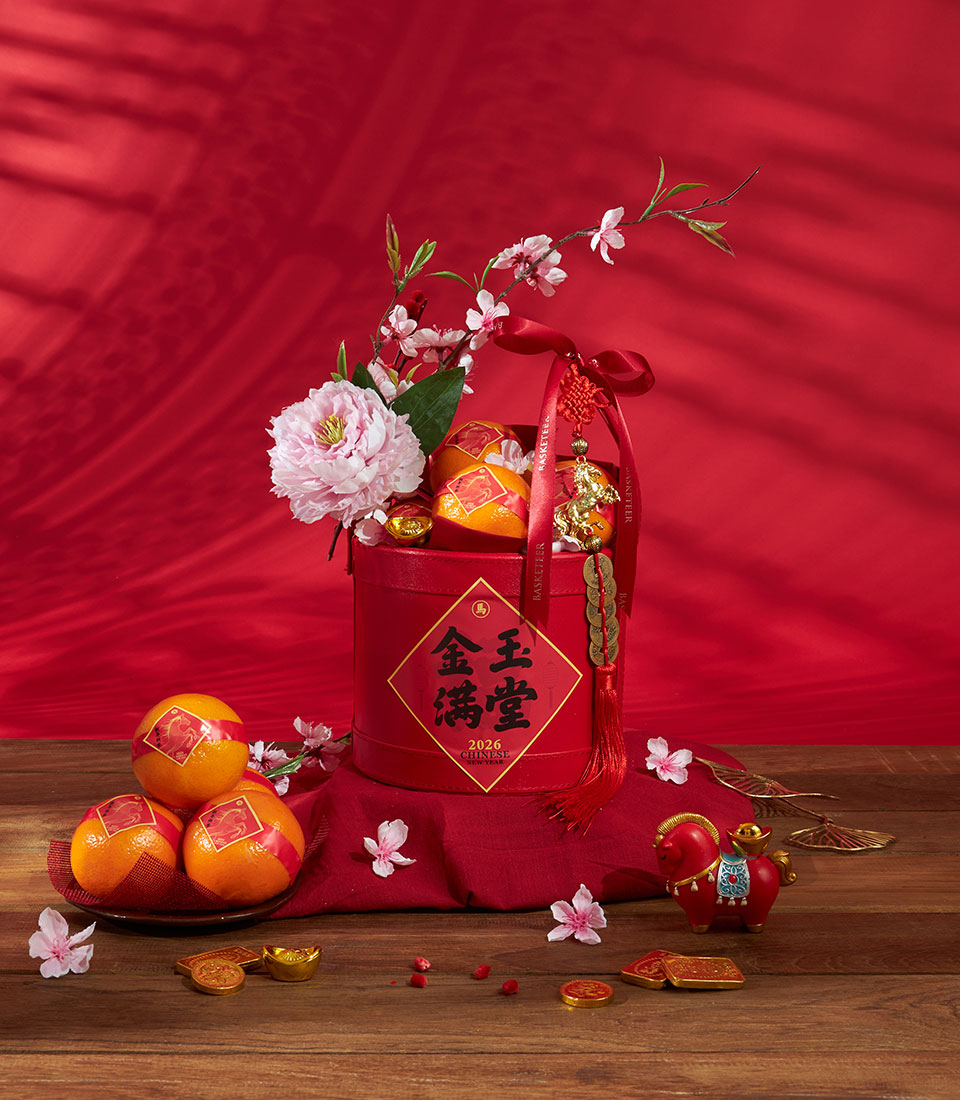 Premium mandarin oranges in festive red gift box with gold accents and cherry blossoms for Chinese New Year prosperity