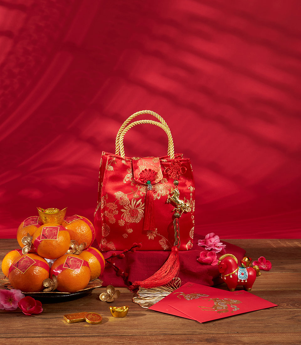 Mandarin oranges gift bag with red satin handbag, gold accents, and traditional Chinese New Year prosperity symbols